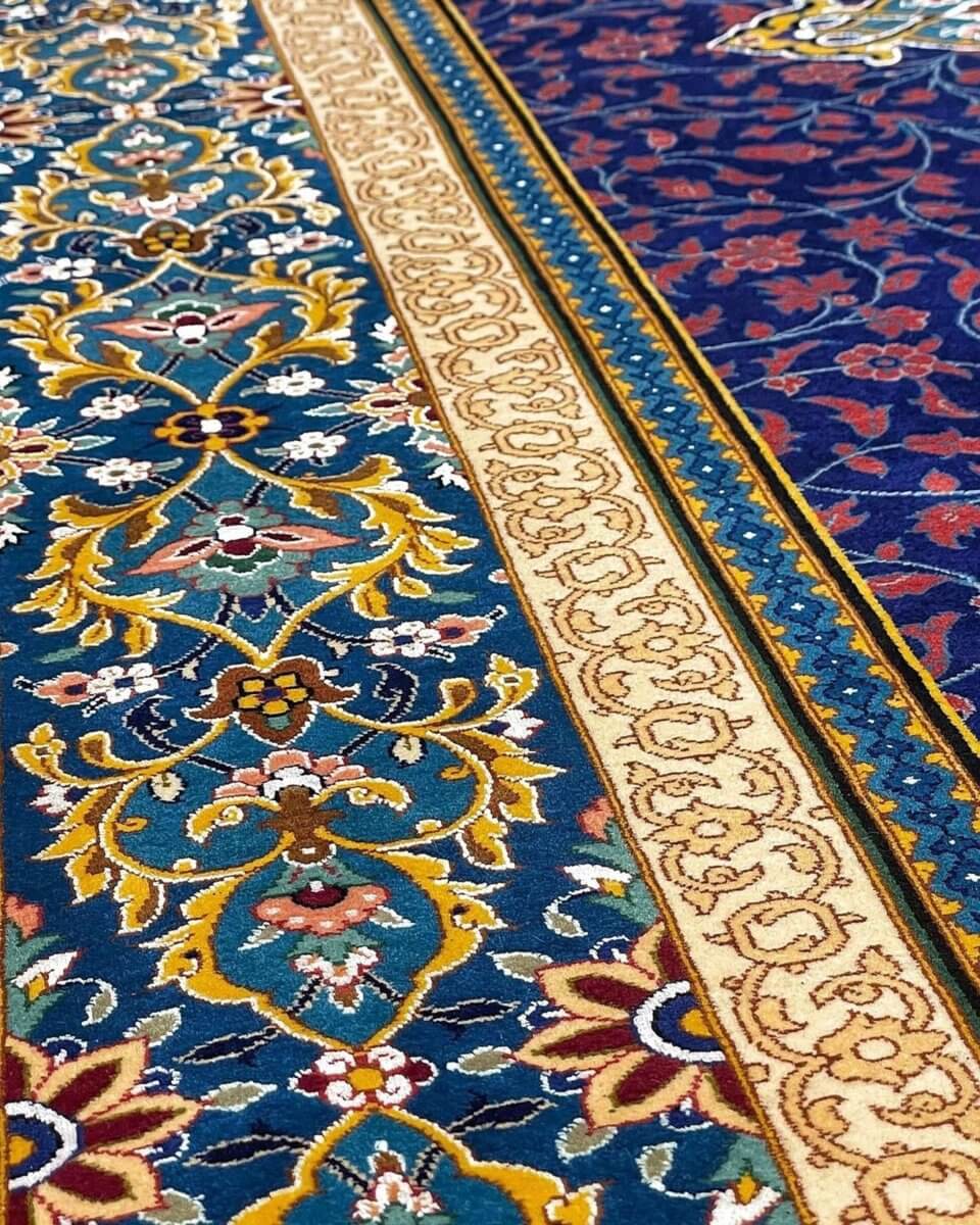 Traditional Persian Rug from Isfahan - A detailed shot of the central medallion and surrounding floral patterns, emphasizing the rug's intricate design and vibrant color palette.